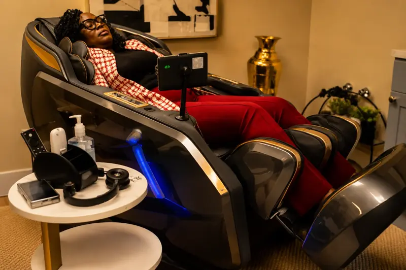 A guest relaxing in a massage chair
